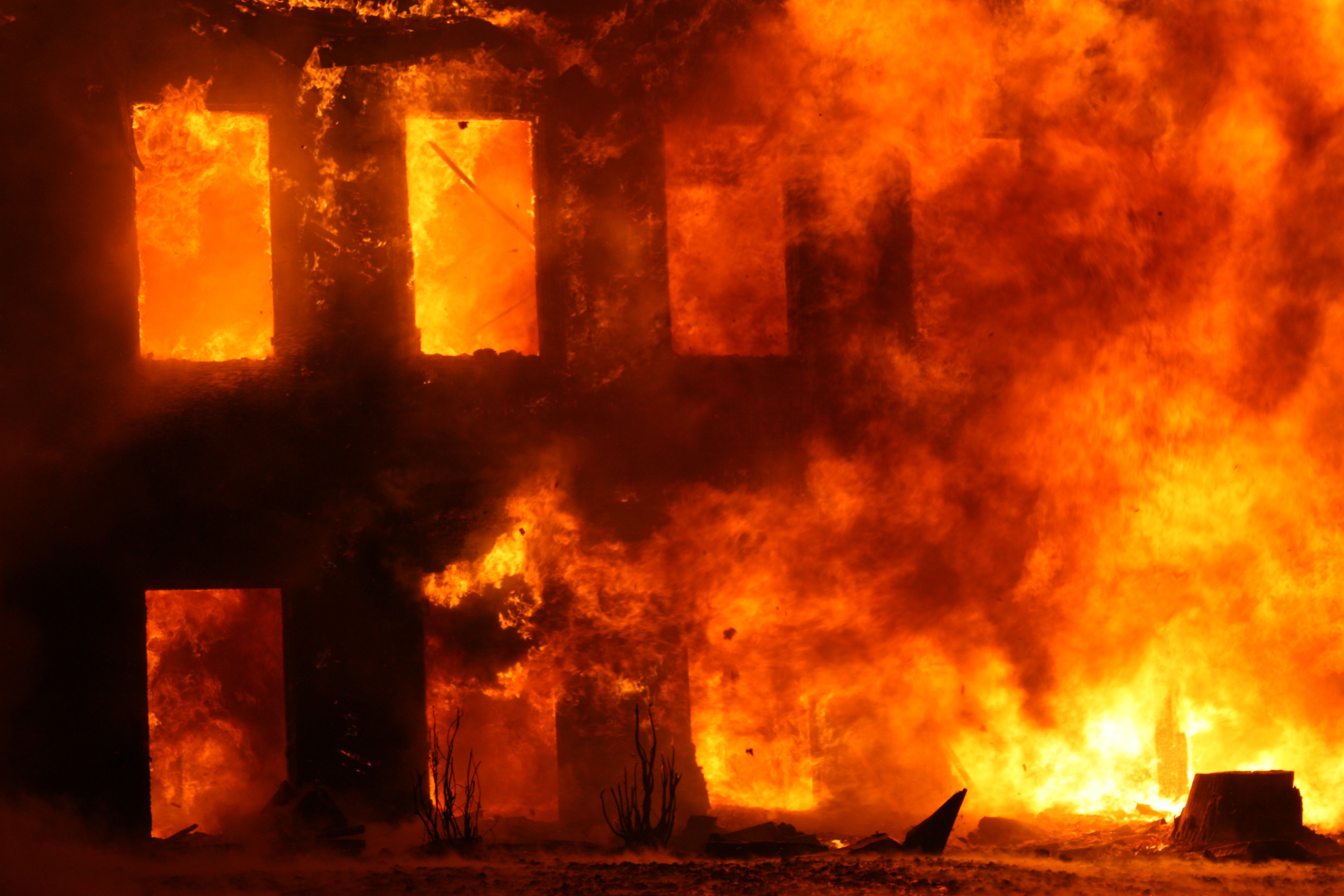 Dramatic scene of a building engulfed in flames, showcasing the power and danger of fire